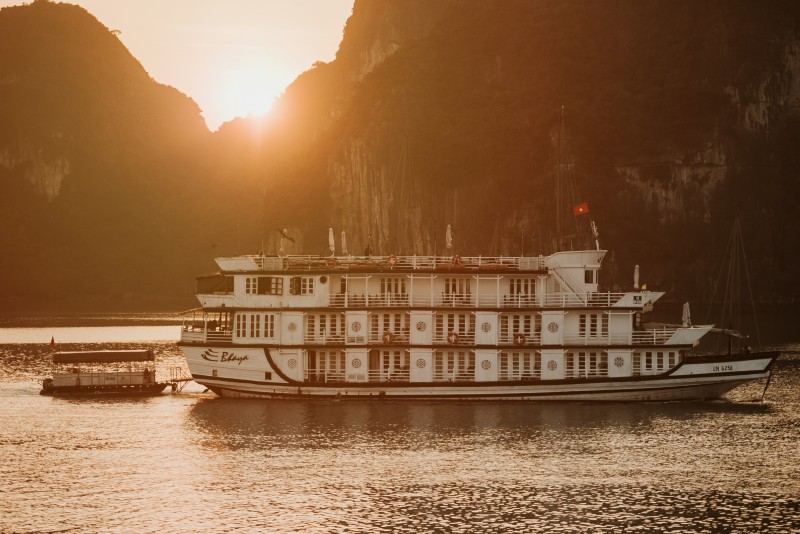 Bhaya Classic Cruise ship sailing at sunset in Halong Bay