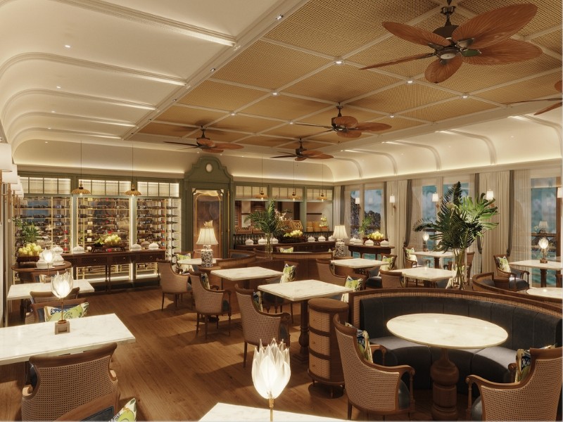 Spacious dining room aboard Bhaya Soul Cruise with wooden accents, artful lighting, and bay views through wide windows.