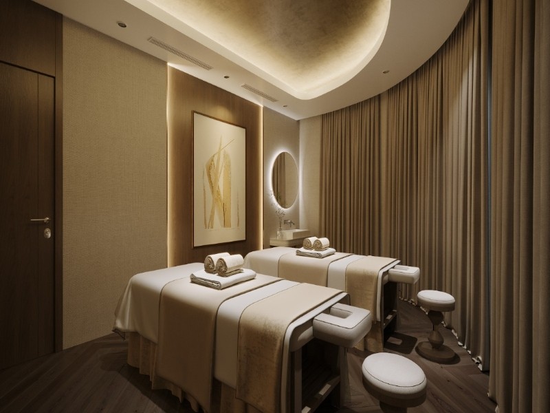 Elegant double spa room on Calista Cruise featuring two massage beds, soft lighting, and warm, soothing decor.