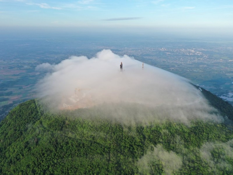 Ba Den Mountain Peak Engulfed in Clouds The peak of Ba Den Mountain covered in mist and clouds, offering a mystical view of Tay Ninh.