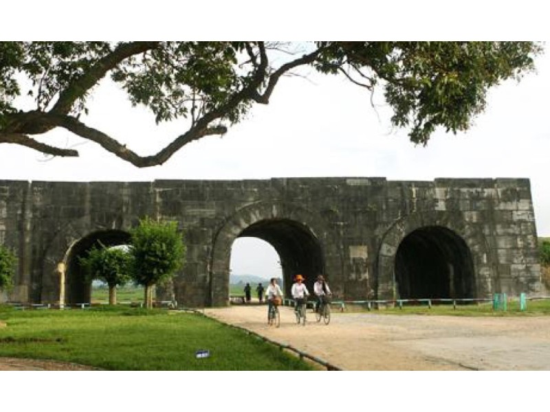 Cyclists Near Ho Citadel Thanh Hoa Cyclists near the Ho Citadel in Thanh Hoa under a tree-lined path