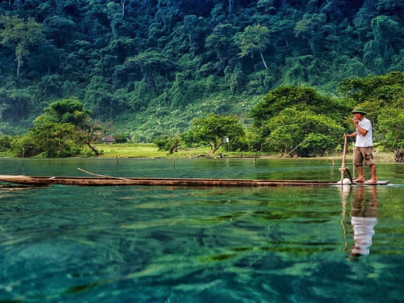 Fisherman on Ba Be Lake in Bac Kan Local fisherman paddling on Ba Be Lake in Bac Kan