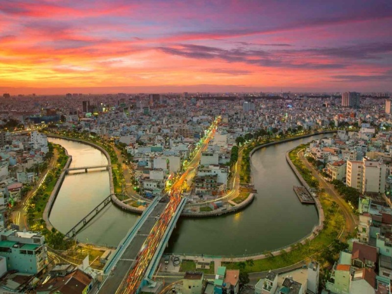 Ho Chi Minh City Sunset Over Canal A stunning sunset over the canal and the expansive cityscape of Ho Chi Minh City.