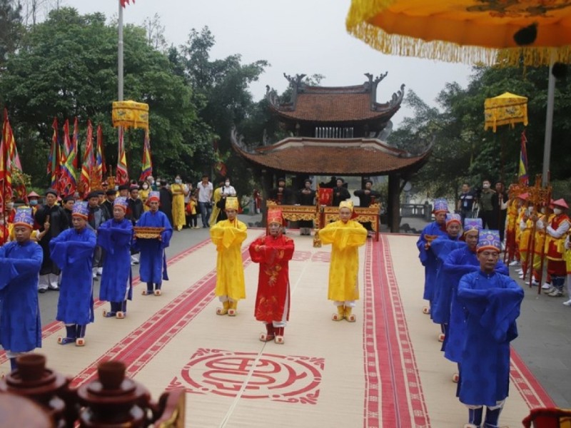 Hung King Temple Festival Traditional procession at the Hung King Temple Festival in Phu Tho, with participants in colorful ceremonial attire