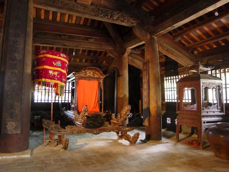 Interior of Tho Ha Village Communal House Inside the Tho Ha communal house with traditional wooden architecture and ceremonial objects
