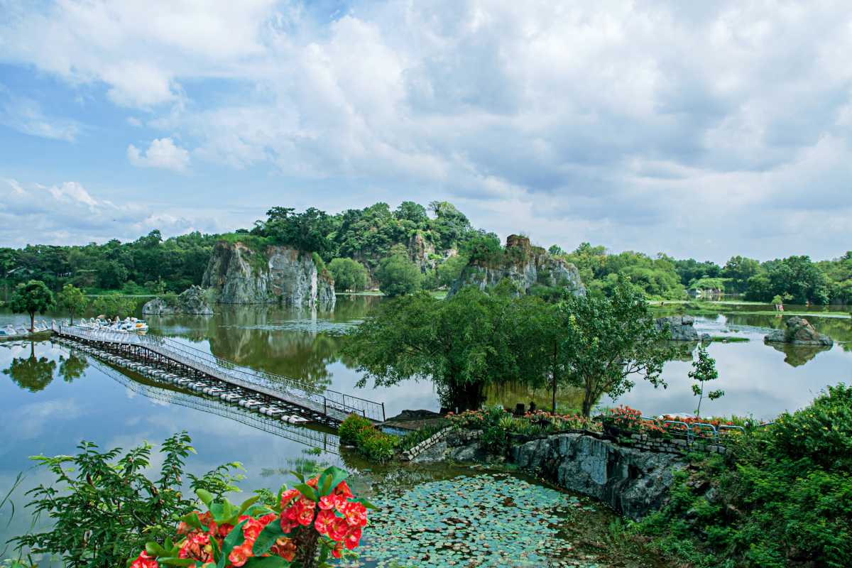 Long An Travel Guide scenic lake and limestone hills view Scenic lake with limestone hills and paddle boats in Long An Travel Guide nature park