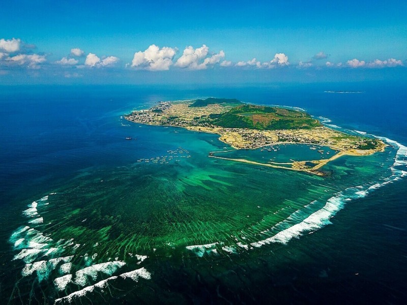Ly Son Island in Quang Ngai! Aerial view of Ly Son Island in Quang Ngai, surrounded by pristine blue waters and agricultural lands.