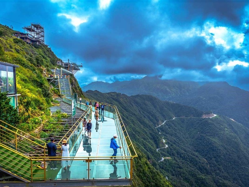 Sa Pa Glass Bridge – Elevated Adventure Tourists walking on Sa Pa glass bridge with panoramic views of the highlands