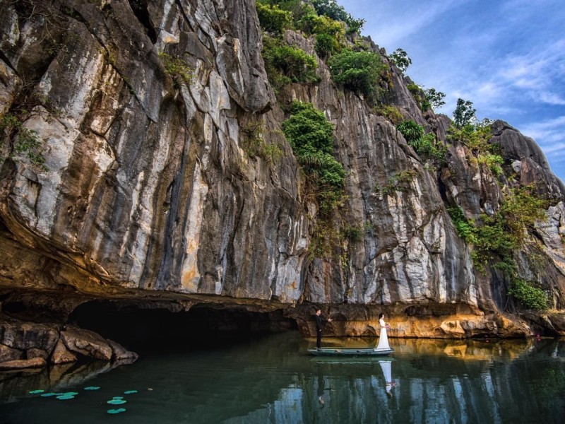 Scenic View at Kim Son Cave in Thanh Hoa Scenic view of Kim Son Cave in Thanh Hoa with limestone cliffs and water