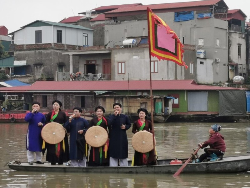Tho Ha Village Festival on the River Locals performing traditional songs on a boat during the Tho Ha Village Festival in Bac Giang