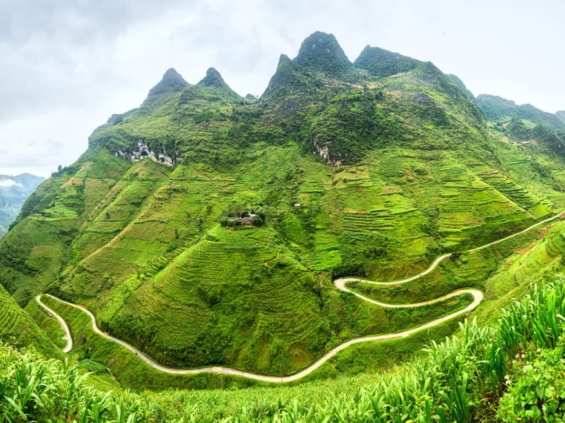 Touring Ha Giang Vietnam Tourists exploring the Ha Giang province in Vietnam, showcasing the scenic routes and cultural richness of the region.