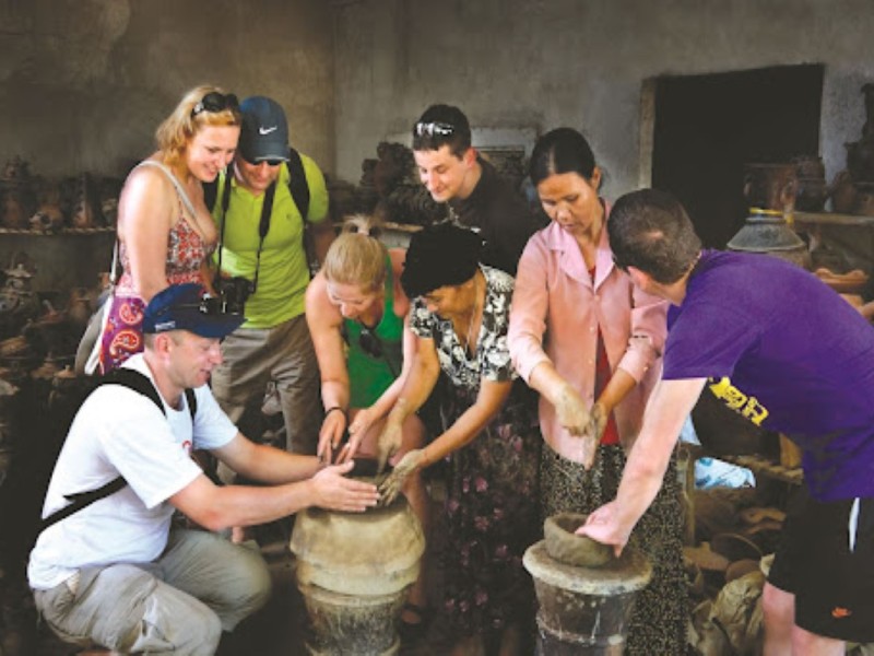 Tourists Learning Pottery at Bau Truc Village Tourists engaged in pottery-making at Bau Truc Pottery Village, Ninh Thuan
