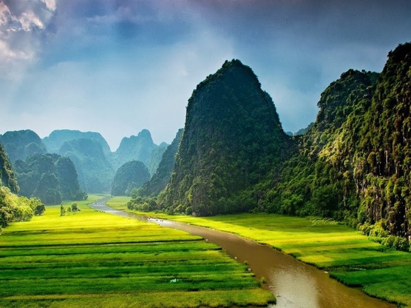 Trang An - Majestic River Landscapes of Ninh Binh Scenic view of Trang An river system in Ninh Binh, with limestone cliffs and lush greenery.