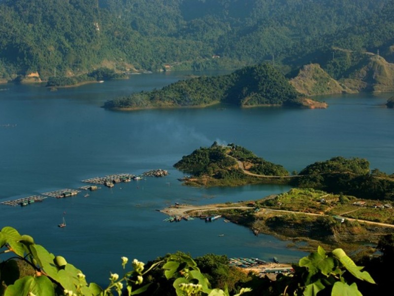 Tuyen Quang's Lam Binh District - A Treasure of Eco-Tourism A picturesque view of Lam Binh District in Tuyen Quang, showcasing its eco-tourism potential with green mountains and forests.