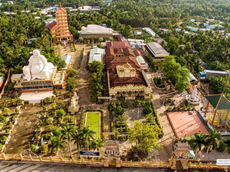 Vinh Trang Pagoda in Tien Giang - Iconic Buddhist Temple Aerial view of Vinh Trang Pagoda, a stunning Buddhist temple in Tien Giang, surrounded by lush greenery.