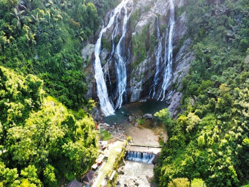 White Waterfall Minh Long in Quang Ngai! Stunning view of White Waterfall Minh Long in Quang Ngai cascading over lush green forests.