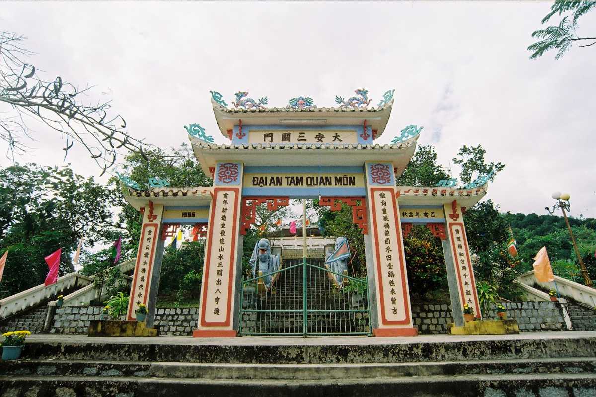Ancient Am Chua Temple gate surrounded by lush countryside, featured on the Nha Trang biking tour.