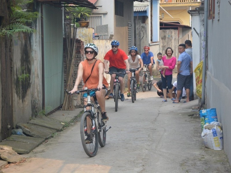 Cyclists enjoying a scenic ride through rustic village streets