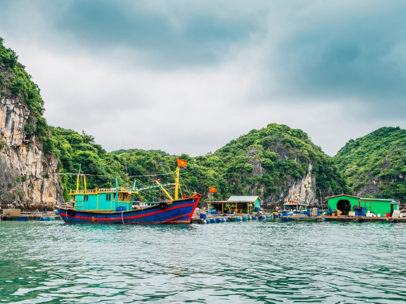 Lan Ha Bay Fishing Village near Cat Ba Island Lan Ha Bay fishing village with houses and boats near Cat Ba Island, surrounded by clear blue waters.